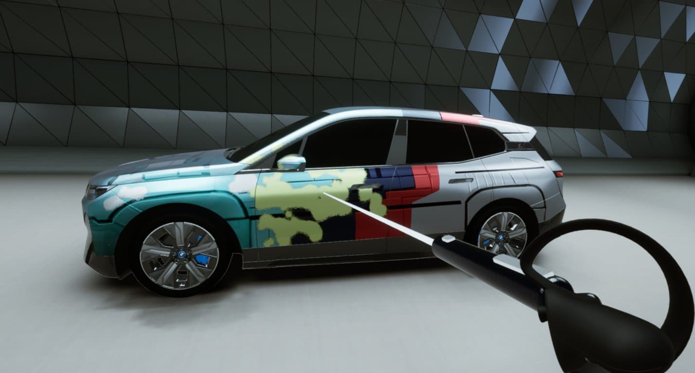 BMW iX being painted with a VR controller inside the virtual experience center